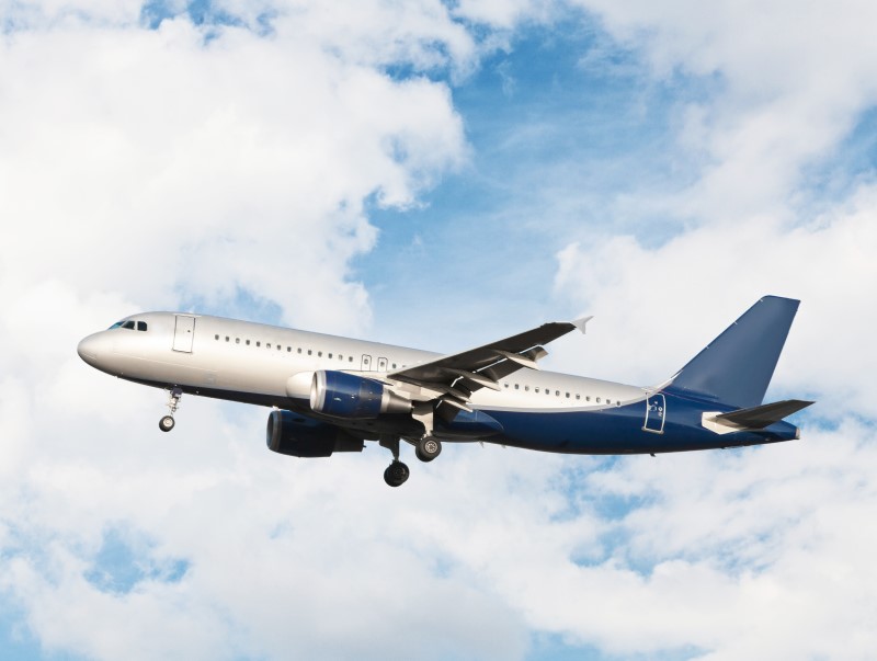 airplane-flying-cloudy-sky